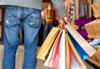 casual man carrying shopping bags in a store